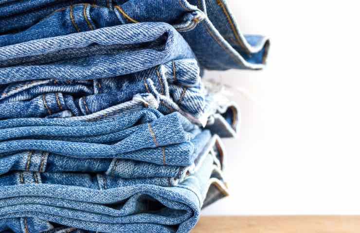 Pila di blue jeans in attesa di essere sfrangiati 